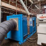 What role can dehumidifiers play at flood-hit construction sites?